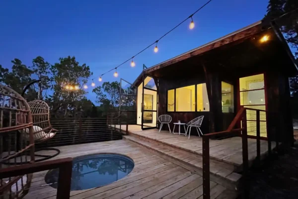 Full-wall French doors open to the porch.